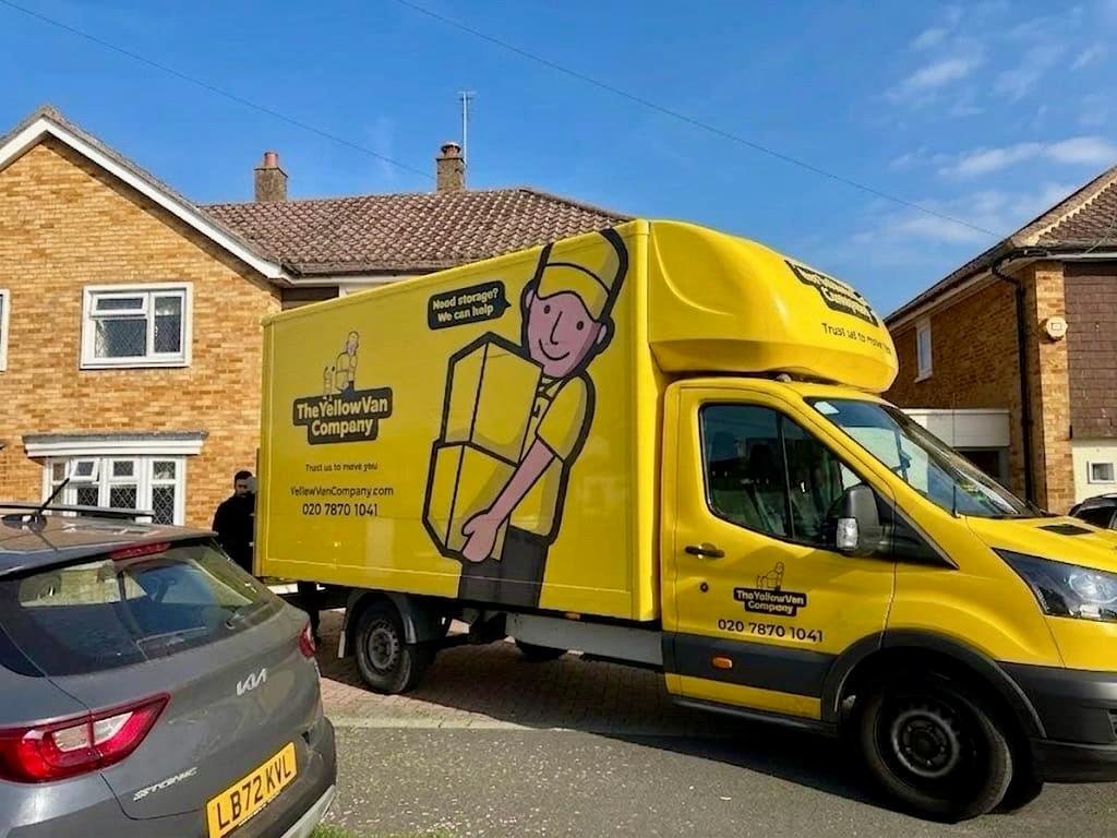 Yellow Van Company branded removals van loading furniture and boxes during a London house move &mdash; careful, professional household removals across the capital